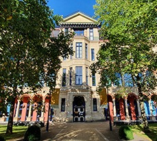 Cambridge Judge Business School exterior in summer sunshine.