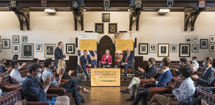 Socially distanced audience clapping the hosts of the Three Deans event held at the Cambridge Union.