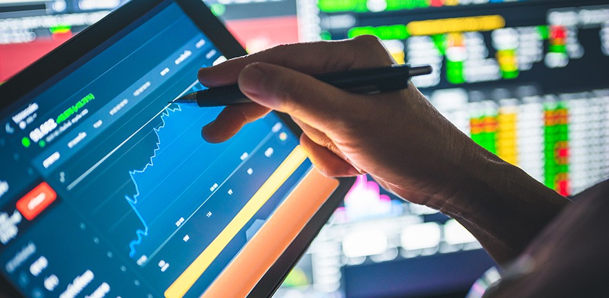 Business person using mobile smartphone app analysing fintech data in relation to the COVID-19 (Coronavirus) pandemic.