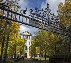 Angled view through the front gates of Cambridge Judge Business School.