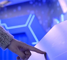 Hand touching a touch screen.