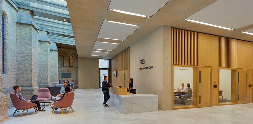 Executive Education delegates in the airy lobby of the Simon Sainsbury Centre at Cambridge Judge.