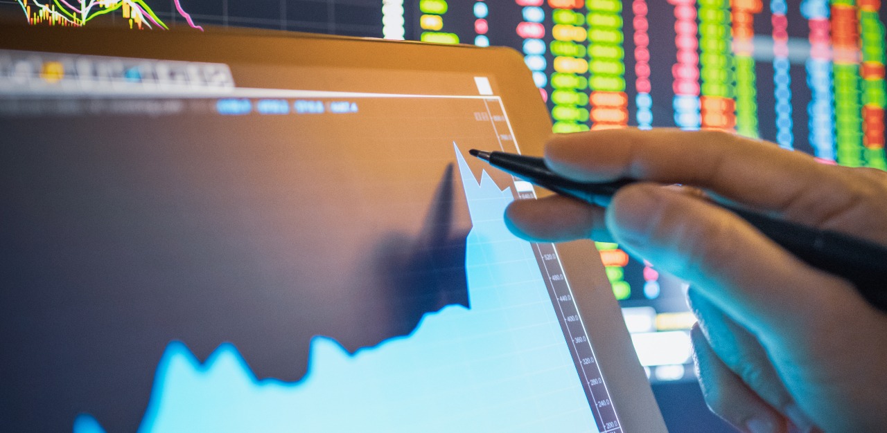 Businessperson analysing stock chart for investment in stockmarket and finance business planning.