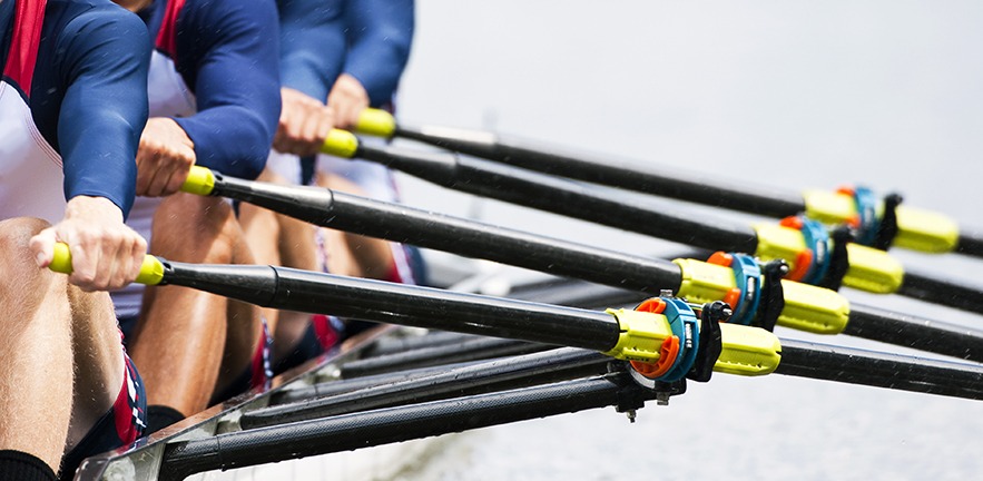 Close up of a men's quadruple skulls rowing team, seconds after the start of their race.