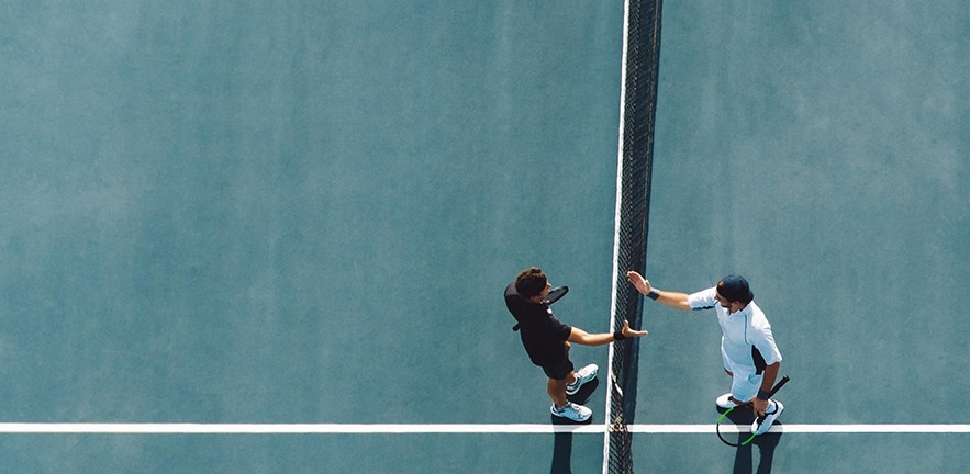 Tennis players shaking hands after a match.