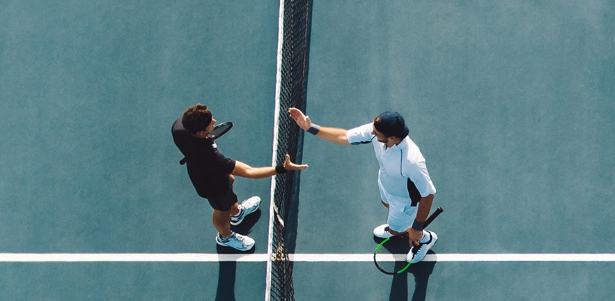 Tennis players shaking hands after a match.
