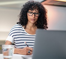 Young businesswoman working from home on a laptop.