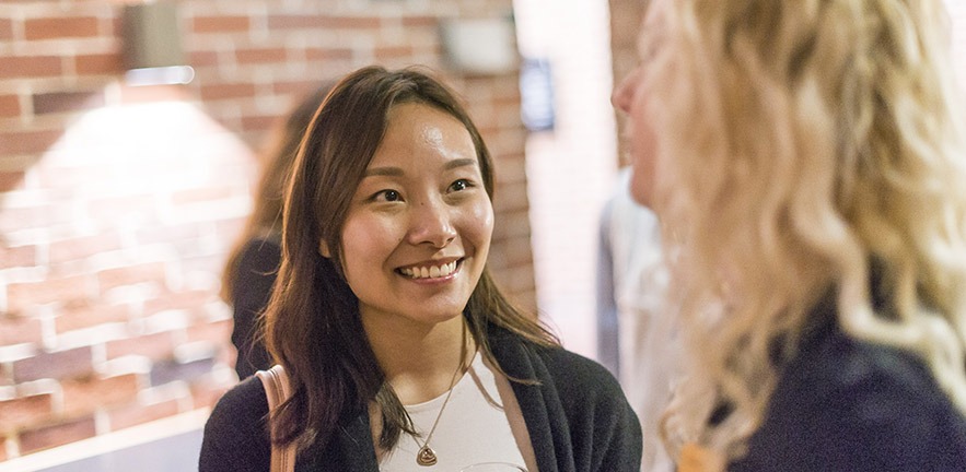 Smiling young woman at a network event.