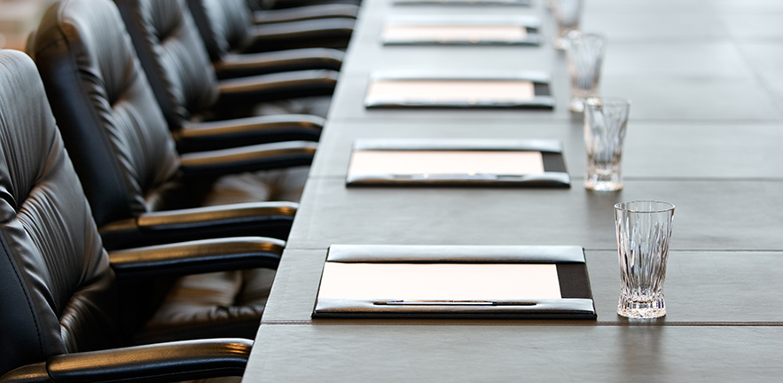 The boardroom table is set for a meeting.