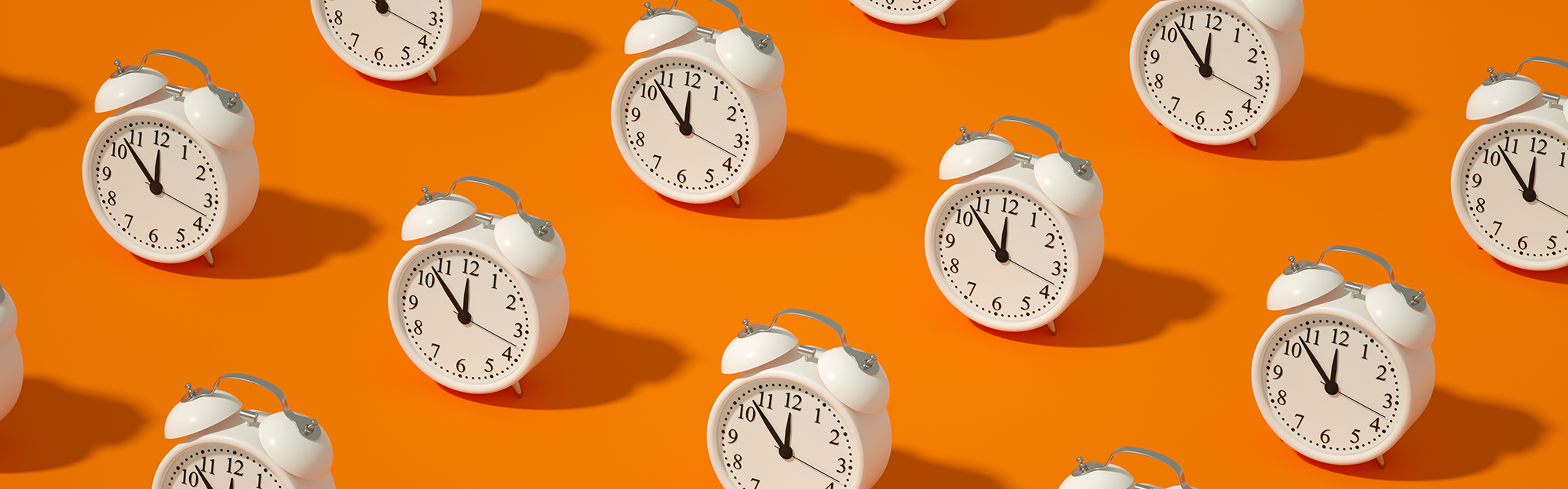 Illustration of multiple alarm clocks on a bright orange background.