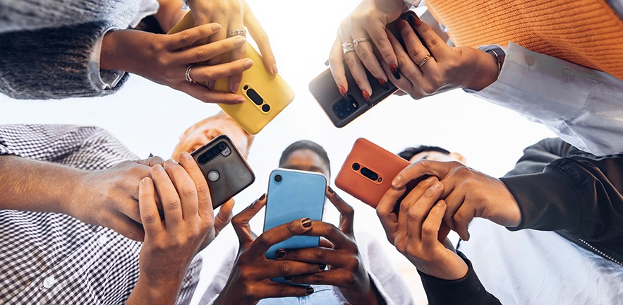 People in a circle using their mobile phones.