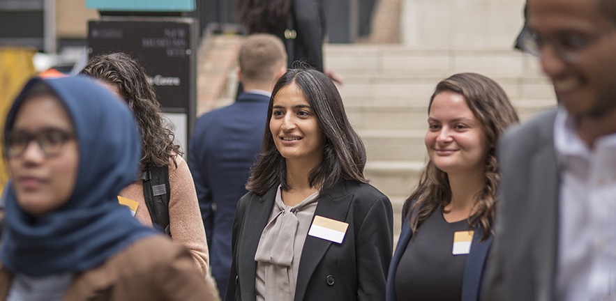 Group of Cambridge MBA students with the focus on two female students.