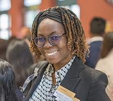 Black female MBA student smiling.