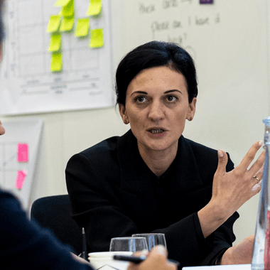 A female delegate explaining a solution to a question in the classroom.