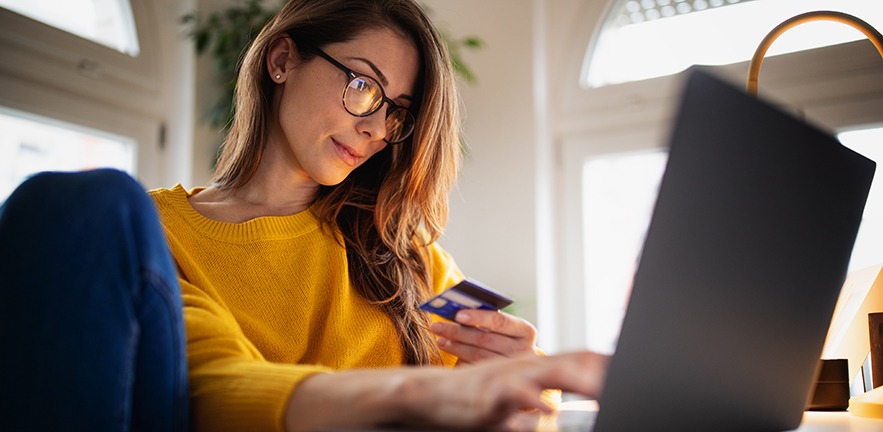 Women using credit card and laptop: a new roadmap for the future of open banking in the UK.