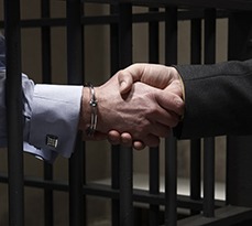 Two prisoners shaking hands.