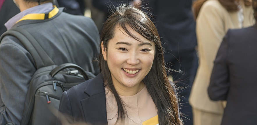 Female MBA student in a crowd.