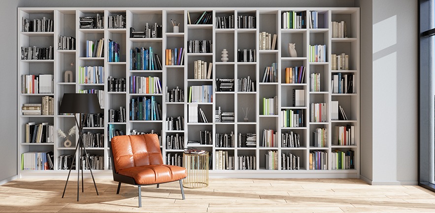 Room with bookshelves full of reading materials and a comfy armchair to read in.