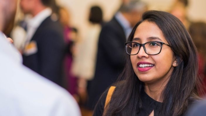 Cambridge Judge student in conversation.