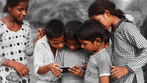 Group of children using smart phone.