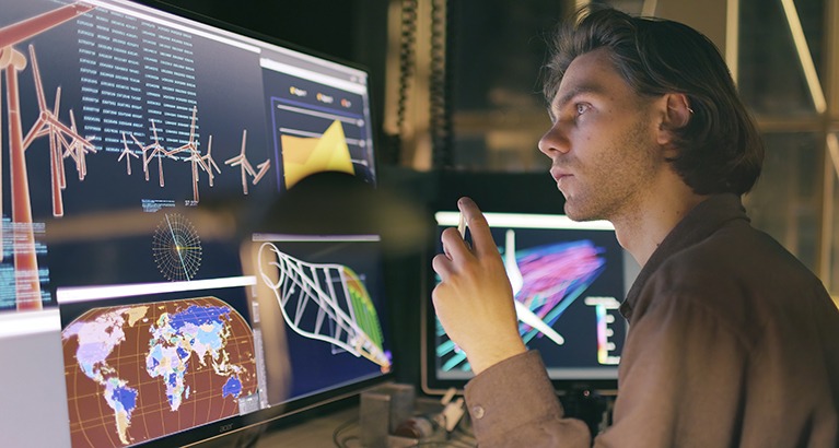 Man working on wind turbine design on his computer.