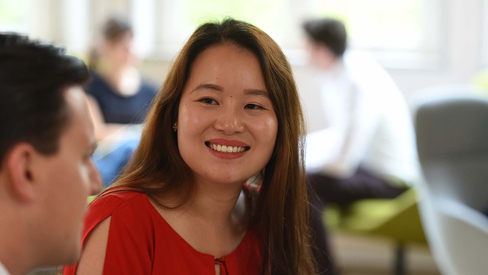 Woman smiling at colleague.