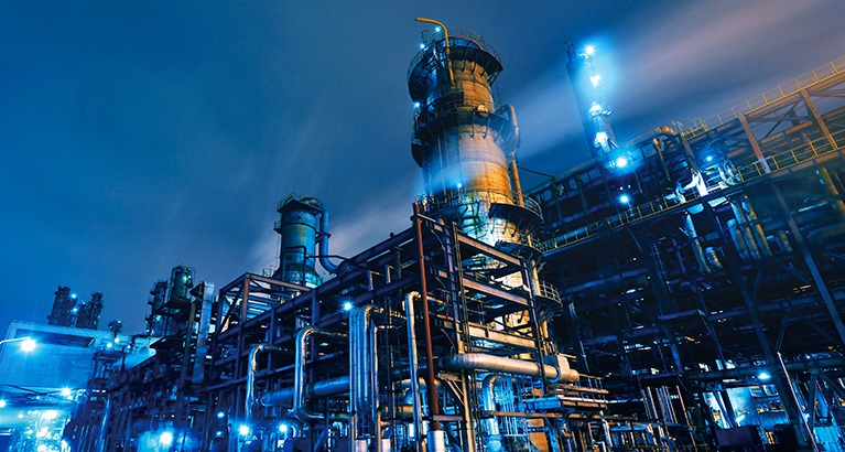 Oil refinery, chemical and petrochemical plant at night.