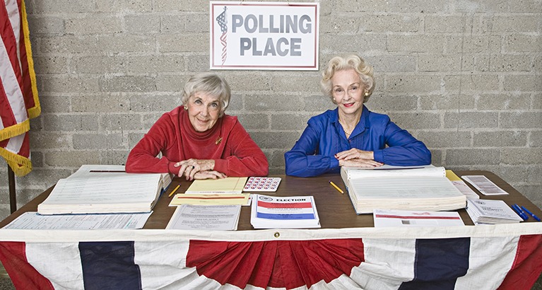 Poll workers staffing a table at a polling station in the US.
