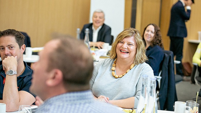 Woman smiling in a classroom.