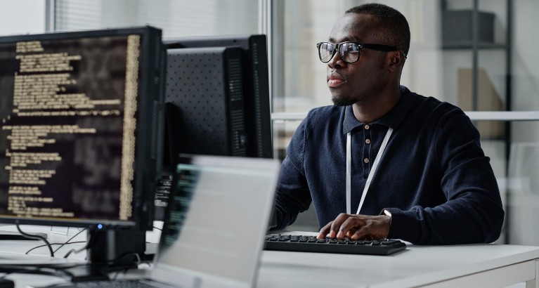 Guy with glasses using a computer.