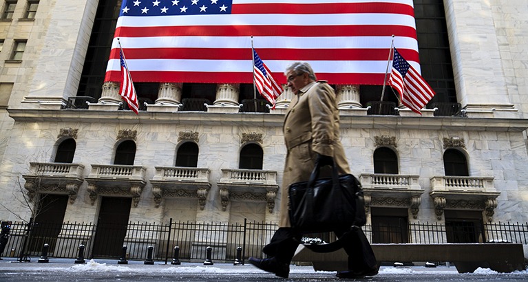 A business man walks outside the New York stock exchange in New York City.