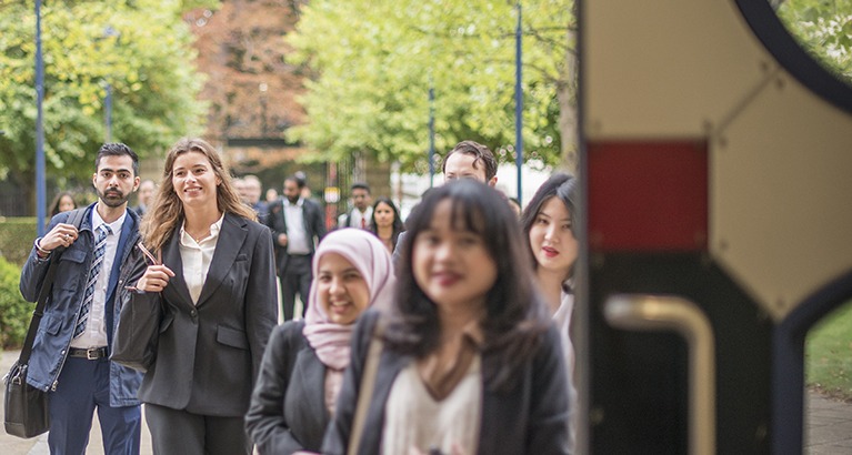 MBA students walking inside Cambridge Judge.