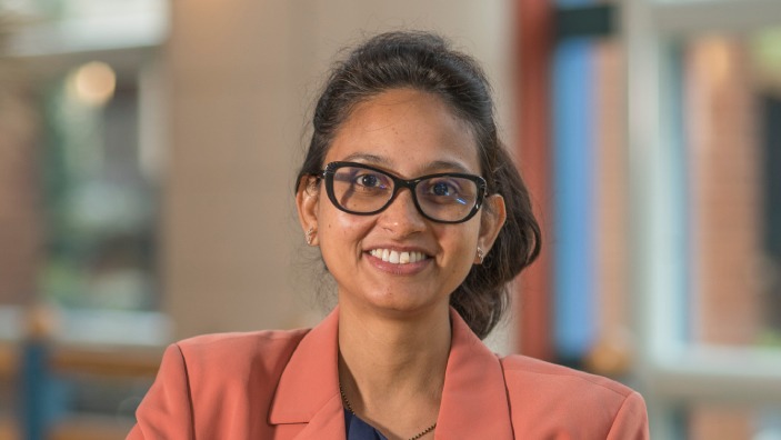 Aditi Goswami inside the Cambridge Judge Business School Atrium