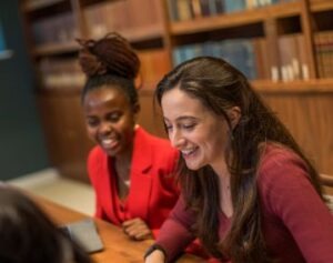 MFin students sitting together and smiling.