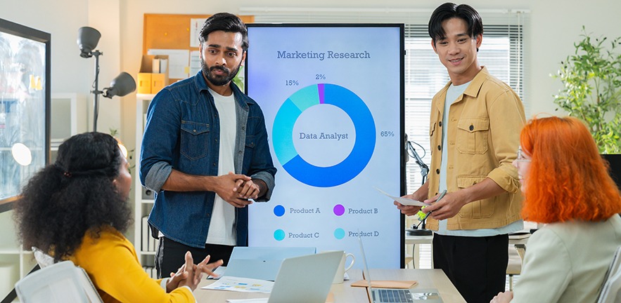 Business team meeting in modern office analysing market research.