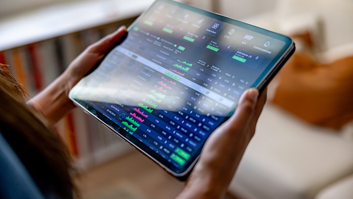 Reviewing markets on a tablet.