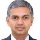 H.E. Periasamy Kumaran looking at the camera