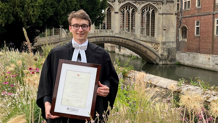 Amaury van Trappen de Buggenoms with his degree certificate in Cambridge.