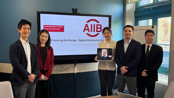 Seoil Jang and others posing in front of their AIIB presentation about digital infrastructure and financing energy.