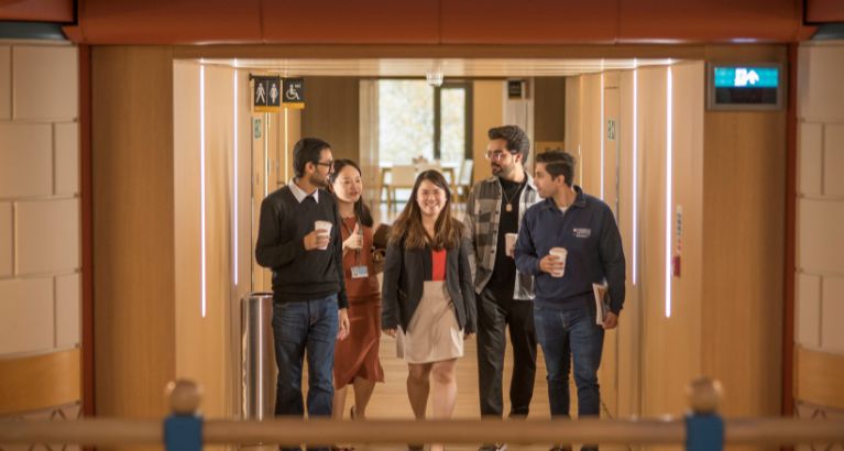 MFin students walking through the hallway.