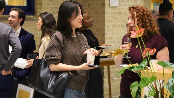 Seoil Jang speaking to someone at a networking event.