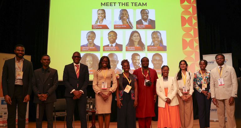 The Cambridge Africa Business Network team standing on stage.