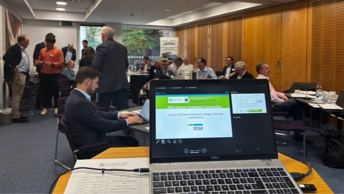 Working on a laptop at Cambridge Capital Group.