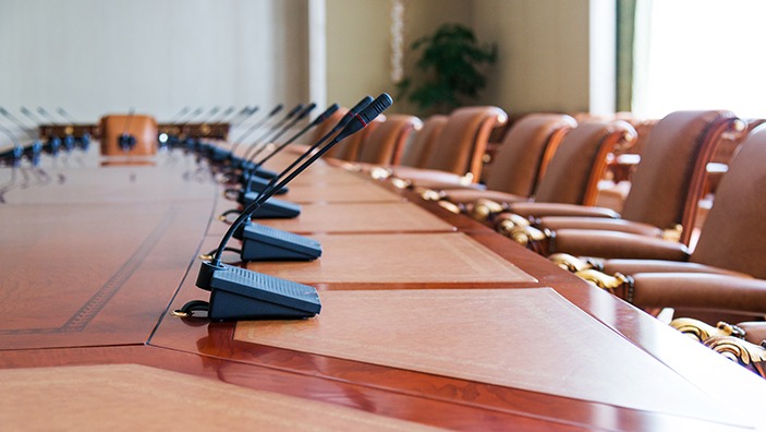 Conference table with group of microphones before conference.
