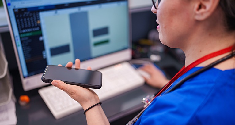 Healthcare professional using AI at a desk.