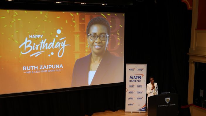 Ruth Zaipuna at CABN, the screen behind her projects her image and the words Happy Birthday.