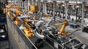 Cars on robotic production line in factory.