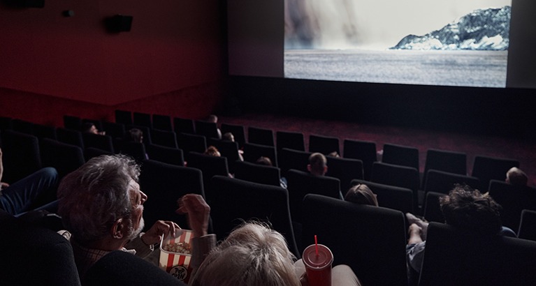 Cinema viewers watch a climate film.