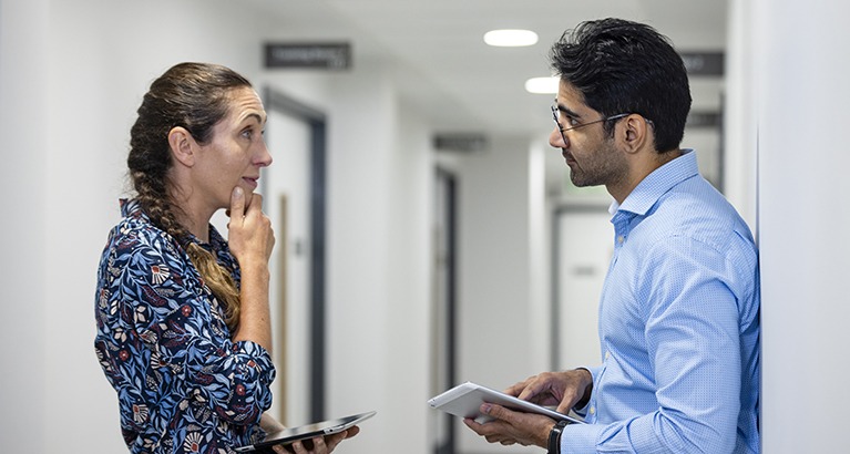 Two colleagues looking at each other having an intense conversation.