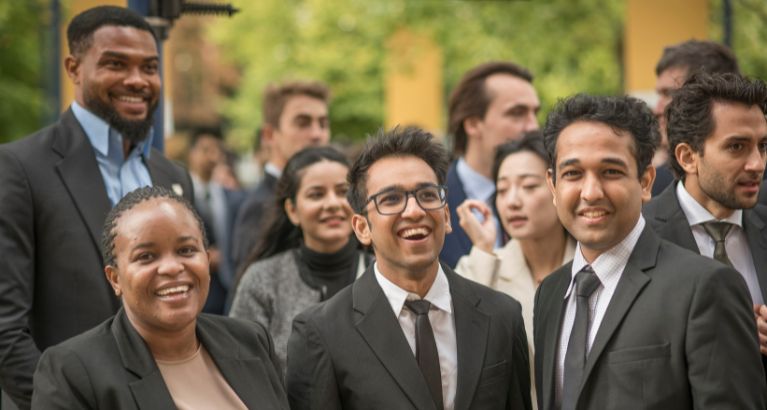 MBA students smiling into the camera.